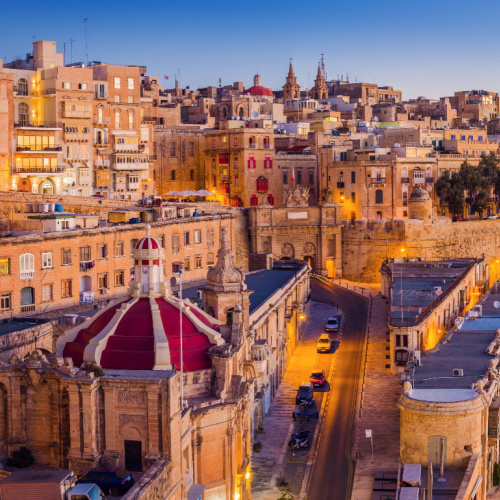 a peaceful dusk of a city with old structures built on a steep area, pictured during the best time to visit Malta.