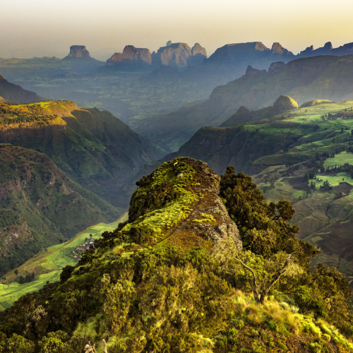 plateaus and and valleys covered with greenery, seen during a sunset on the best time to visit Ethiopia.