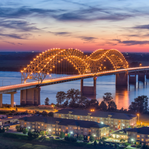 a bridge where its members are decorated with lights, seen during a sunset of one of the best time to visit Tennessee.
