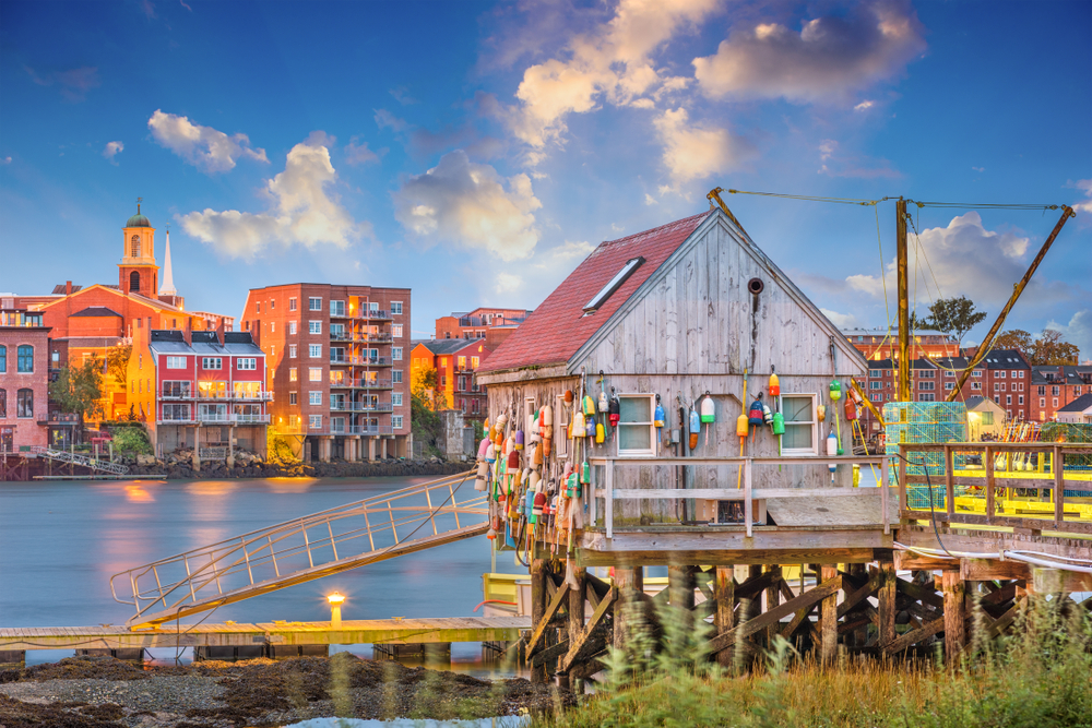 Picturesque image featuring a fishing gear storage shack on stilts on a dock on the water in Portsmouth, NH
