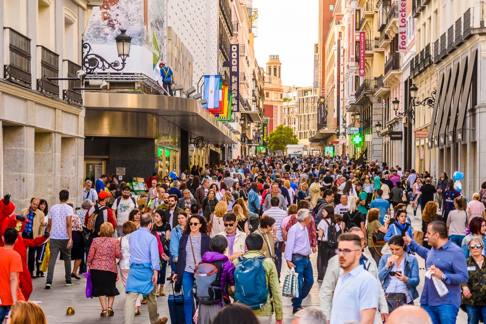 Thousands of people crowded into a small street in Madrid during the summer, the overall worst time to visit