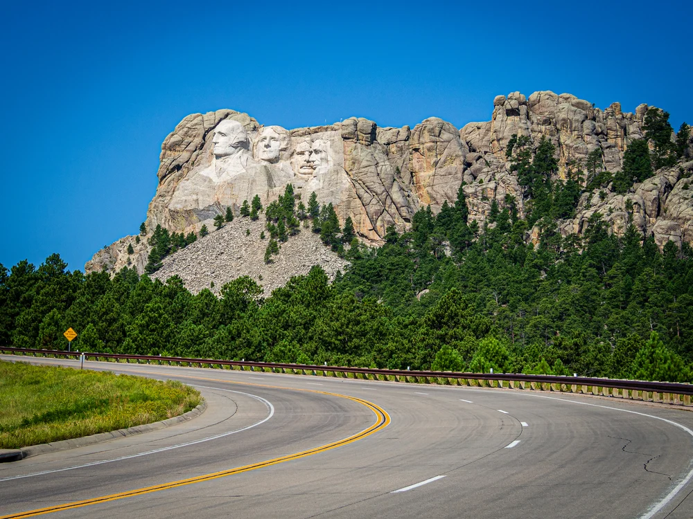 Windy road going by Mount Rushmore during the summer, one of the best times to visit the attraction