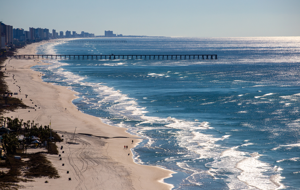 Aerial view of the empty Panama City Beach pictured during the winter, the overall worst time to visit, with nobody there and icy cold water with white caps hitting the shoreline