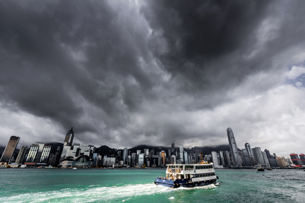Photo of a monsoon over Hong Kong with a ferry getting rocked by the storm pictured during the worst time to visit China, the summer