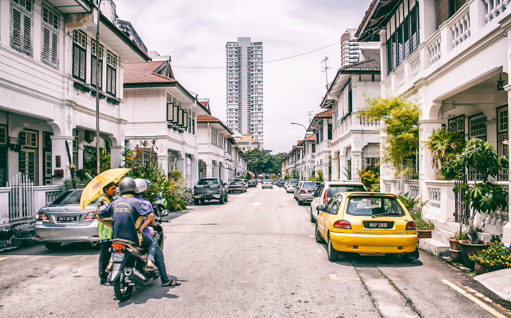 People on a motorcycle pictured making their way down the Georgetown downtown area in the off-season, the least busy time to visit Malaysia