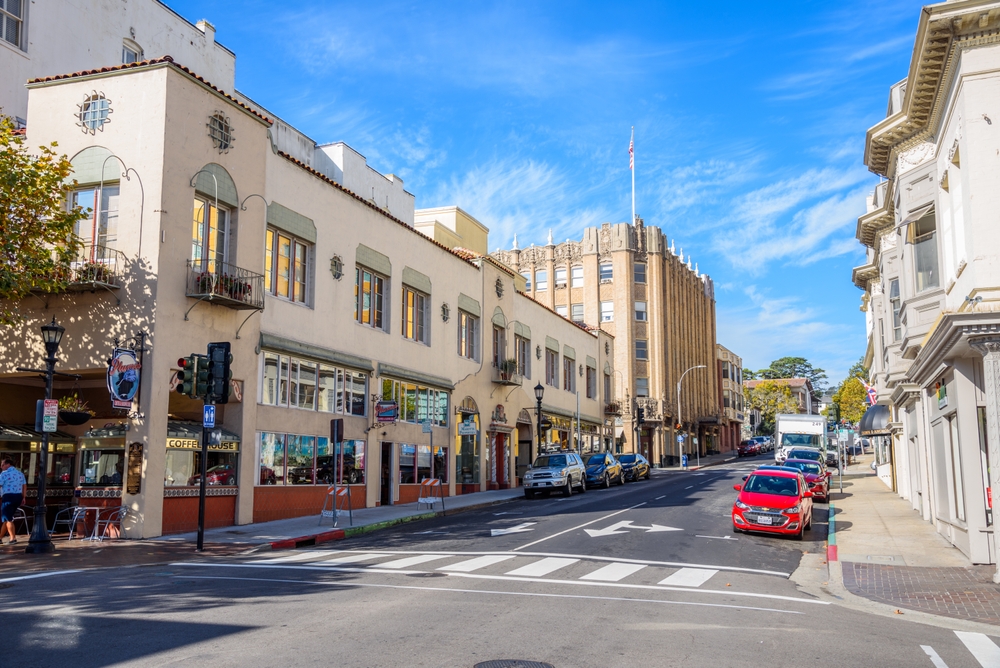 Photo of the historic Franklin Street pictured during the winter, the overall least busy time to visit Monterey, CA, with cloudy skies above the historic downtown