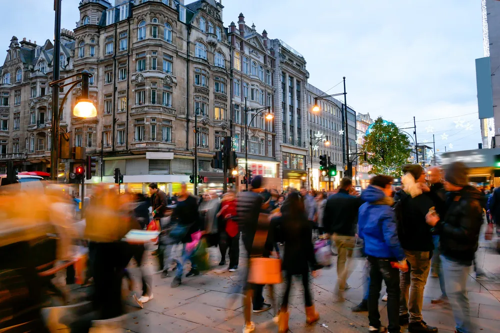 People milling about on Oxford Street at dusk with a blur motion effect for a things to consider section on the best time to visit London