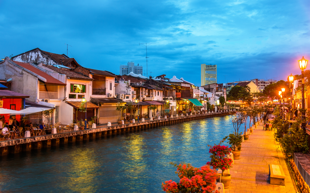 Gorgeous river town of Malacca pictured during the best time to visit Malaysia with a riverwalk running along the water