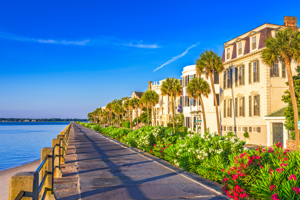 Historic homes on the Battery in Charleston under blue sky with calm seas, pictured during the worst time to visit Charleston
