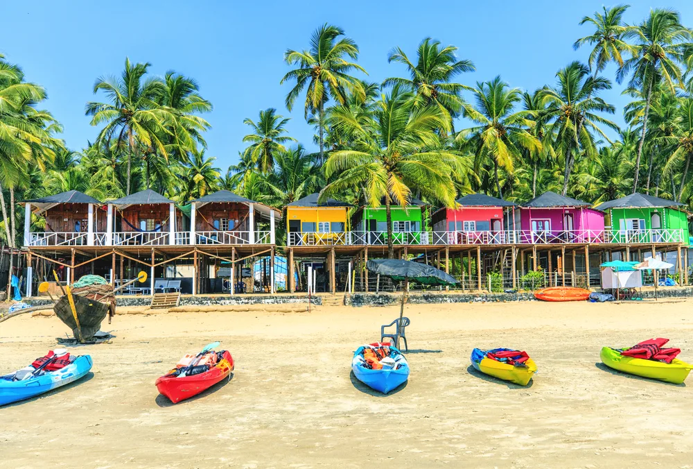Colorful bungalows pictured lining Palolem Beach during the overall best time to visit Goa