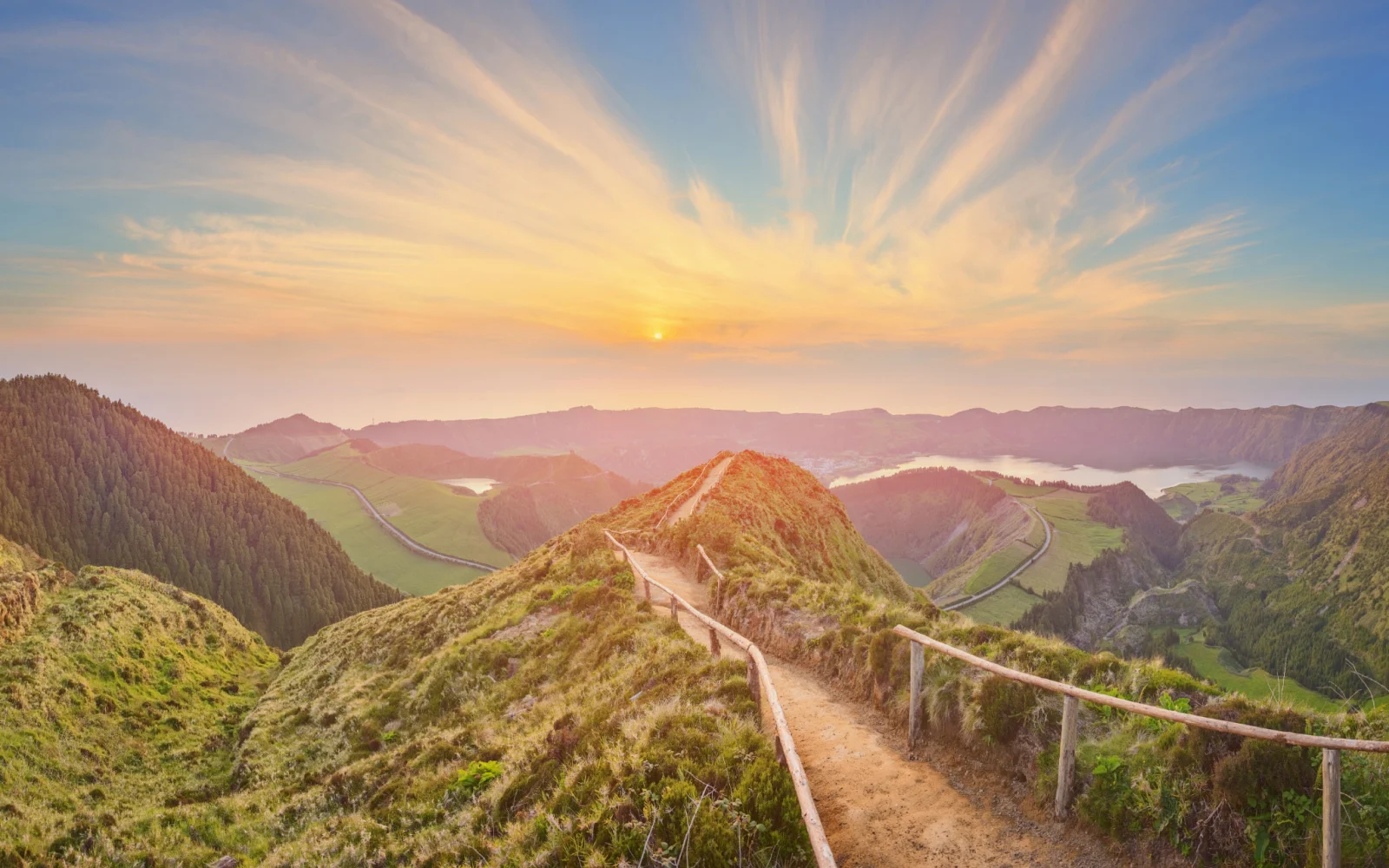 Photo of a mountain landscape with a winding path over Ponta Delgada on San Miguel Island, taken during the overall best time to visit the Azores