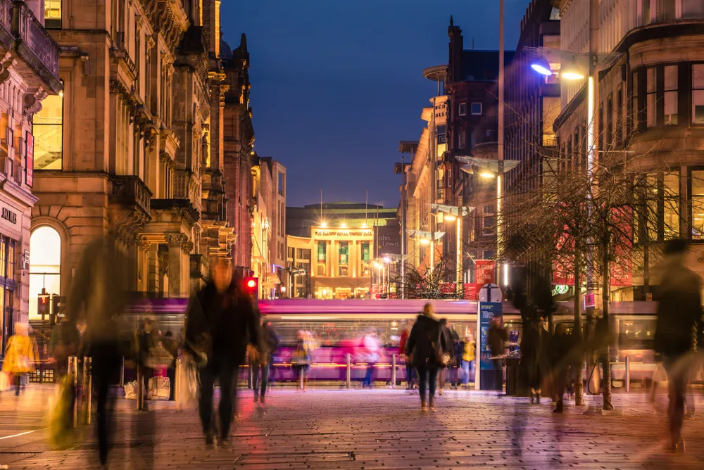 Photo of pedestrians walking along the street during the winter in Glasgow during the overall cheapest time to visit Scotland