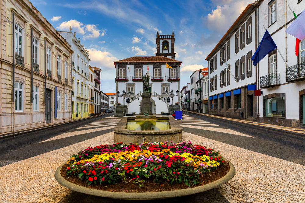 City hall in Ponta Delgada, Azores, pictured during the least busy time to visit with Spanish-style stucco homes lining a gorgeous brick walkway