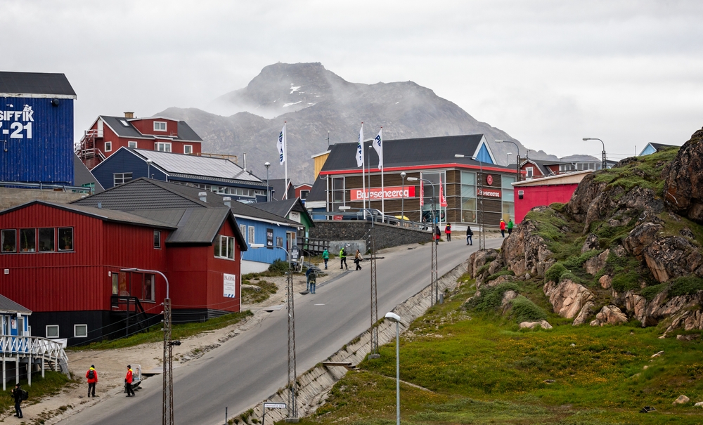 Gloomy day over Sisimiut, Greenland, with a very steep hill next to colorful buildings