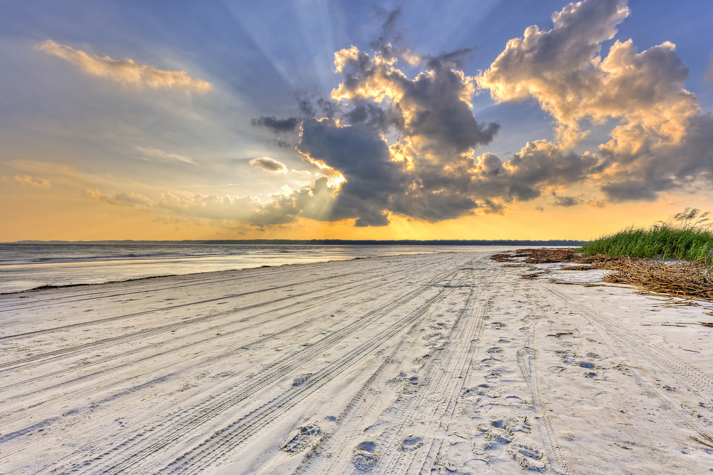 Gorgeous sunset over the expansive and empty beach during the best overall time to visit Hilton Head