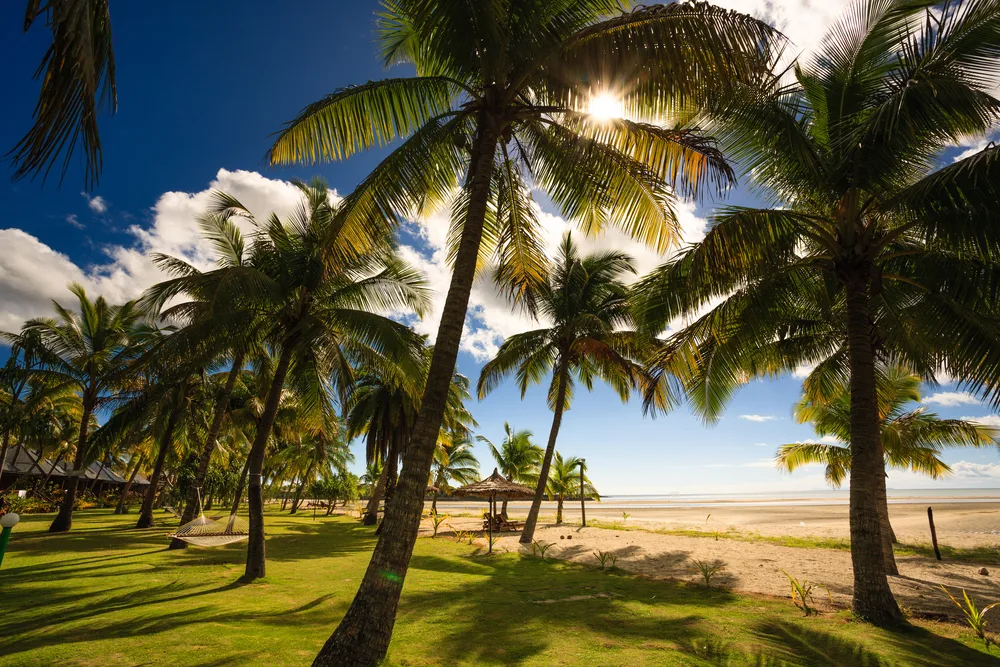Gorgeous beach on Viti Levu pictured during the best time to visit Fiji with blue sky and beige sand