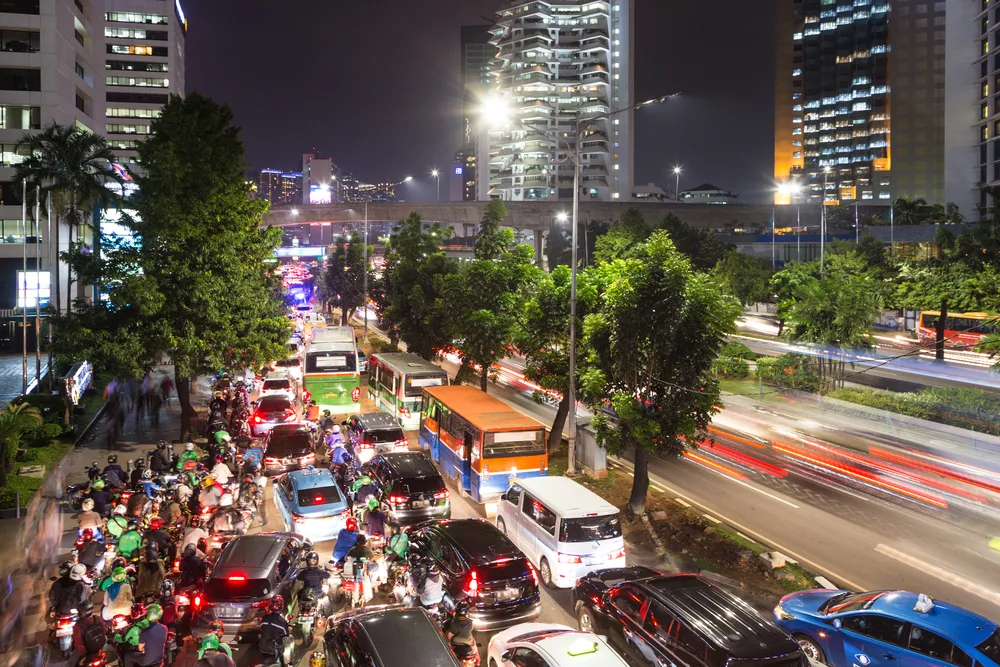 Traffic jam on a road in the central business district of Jakarta pictured during the least busy time to visit Indonesia at night between skyscrapers