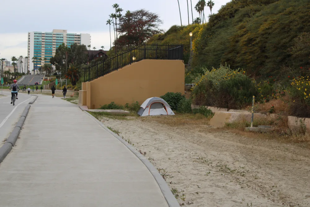 Homeless people in tents along the street in Long Beach for a piece on how to stay safe when visiting