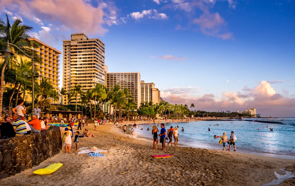 Waikiki beach with tourists all around pictured for a guide to whether or not Hawaii is safe to visit
