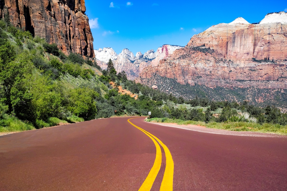 Pictured in the middle of the summer, the worst time to visit Utah, a hot day in Zion National Park as seen from the middle of the road