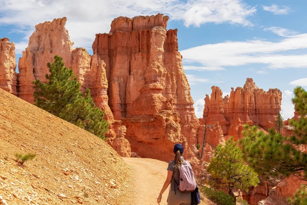 Female backpacker on a hike on Peekaboo Trail during the spring, the overall least busy time to visit Bryce Canyon