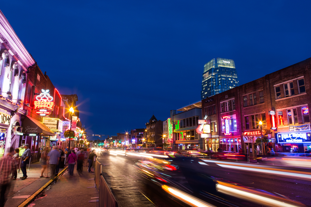 Photo of people walking at night along the main street in Nashville for a guide to the safety of the city