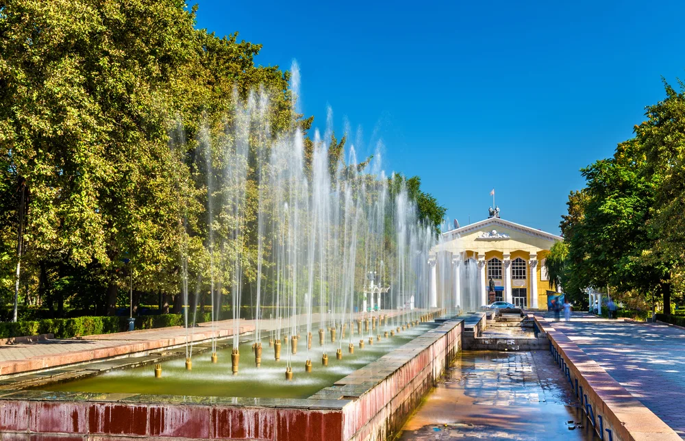 Fountain at the Alley of Youth in Bishkek pictured during the best time to visit Kyrgyzstan with blue skies overhead