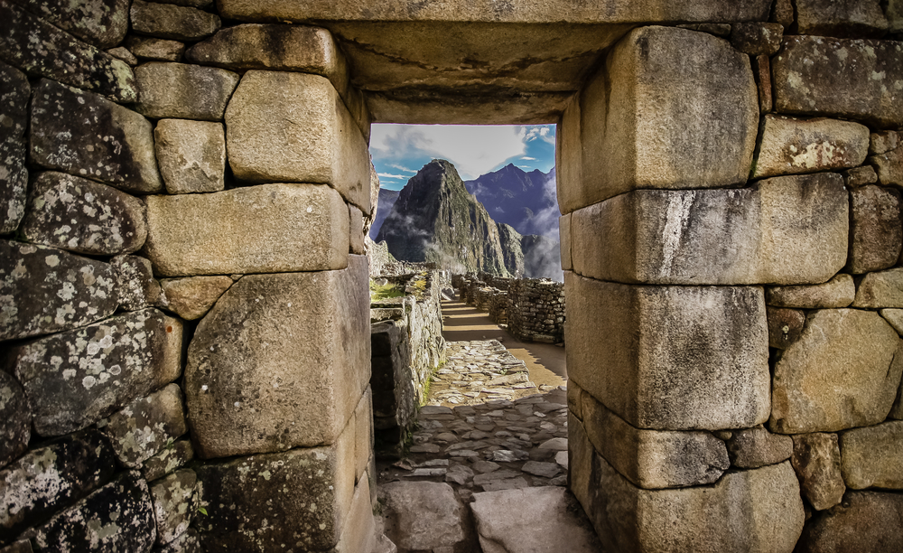 Mountain framed by a window in a house, pictured during the overall best time to visit Machu Picchu