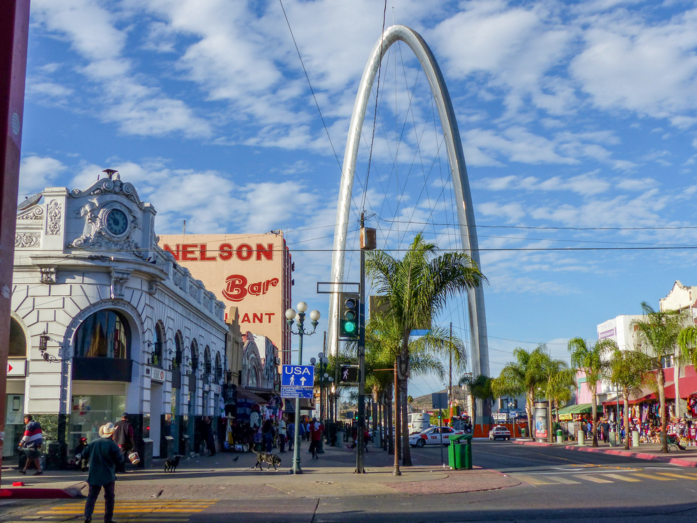 Photo of the arch with people mulling about during the best time to visit Tijuana