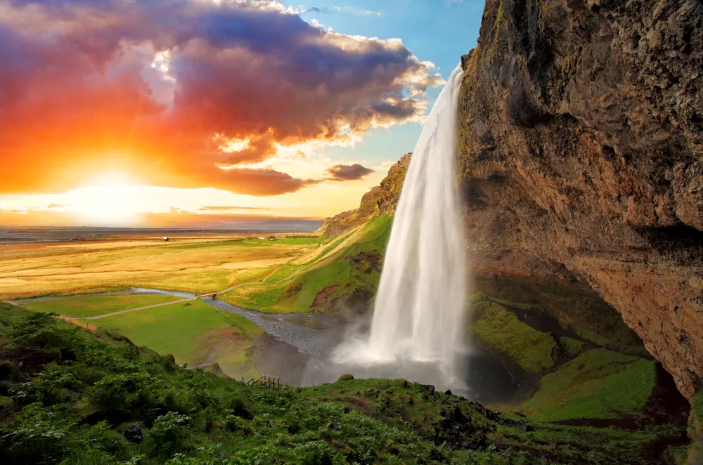 Amazingly gorgeous Seljalandsfoss waterfall pictured at dusk during the overall best time to visit Iceland, the summer