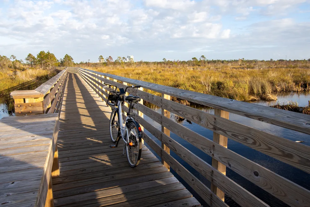 Bike on a wooden walkway at Shelby Lakes in Gulf State Park pictured during the best time to visit Gulf Shores, Alabama