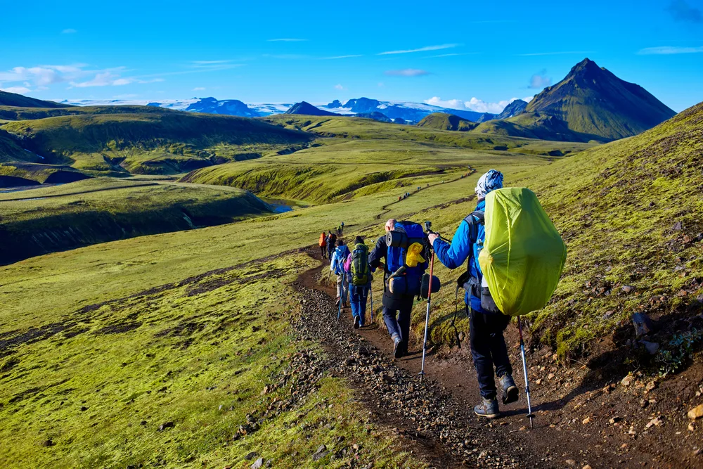 Photo of hikers trekking in the Landmannalaugar National Park during the summer, one of the overall best times to visit Iceland