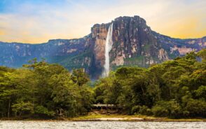 Angel Falls in Canaima National Park seen flowing off a mountain with a sunrise sky during the overall best time to visit Venezuela