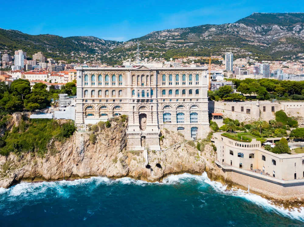 Aerial view of the Oceanographic Museum of Monaco as seen from the coast in Monace-Ville during the cheapest time to visit Monaco