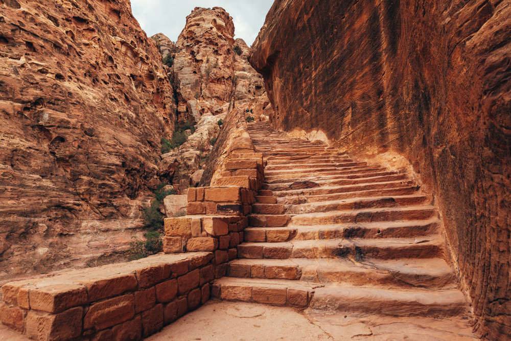 Ancient steps leading to sites in Jordan's ancient rock city for a frequently asked questions section detailing the best time to visit Petra