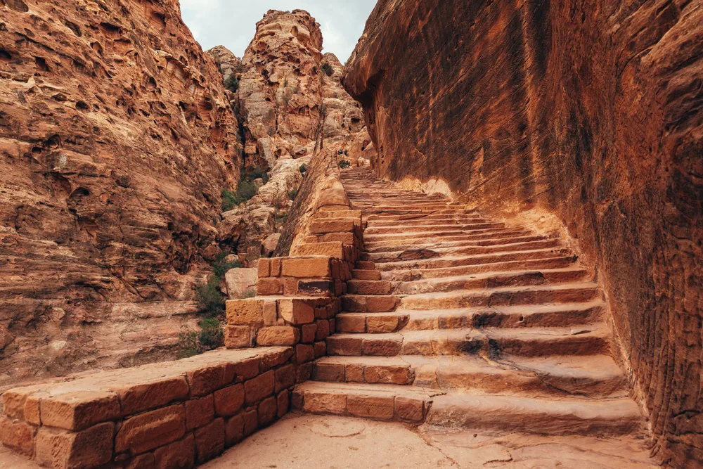 Ancient steps leading to sites in Jordan's ancient rock city for a frequently asked questions section detailing the best time to visit Petra