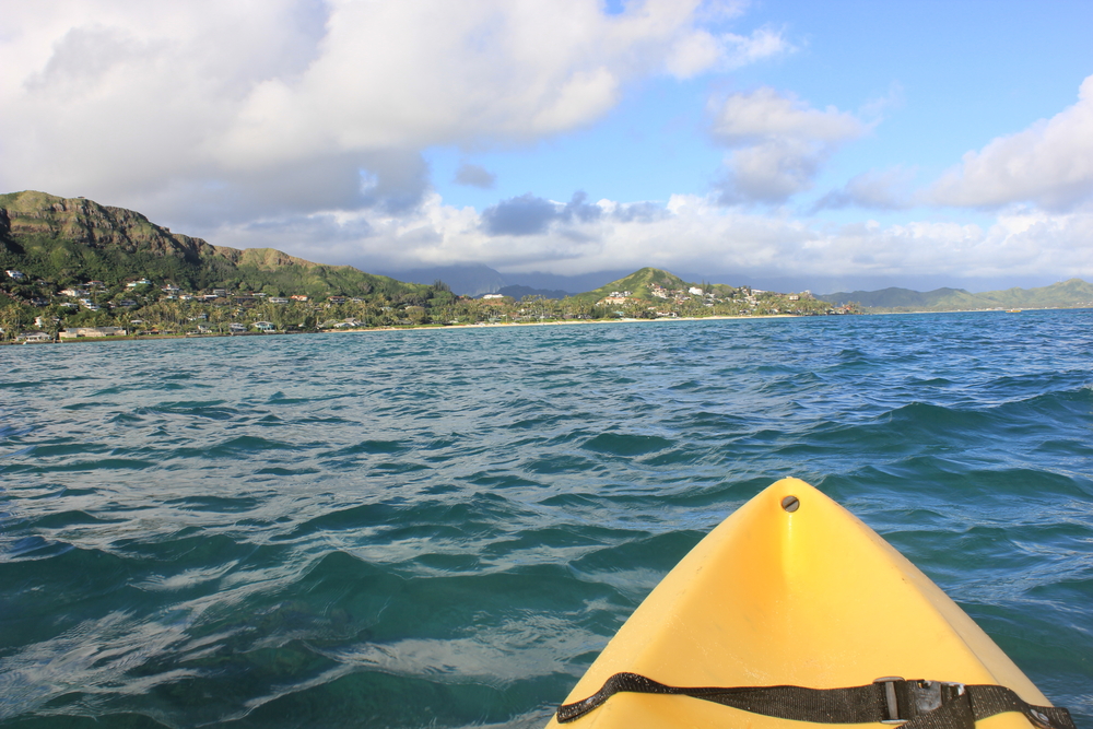 Person kayaking to the Mokuluas from Lanikai Beach on Oahu